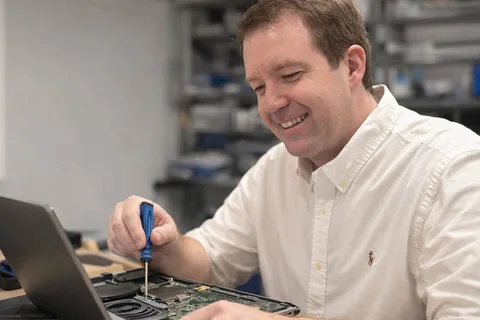 Justin repairing a laptop in Woodstock Georgia